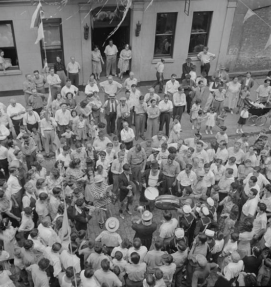 Street music and dancing on Mott Street in New York City, wartime flag ceremony