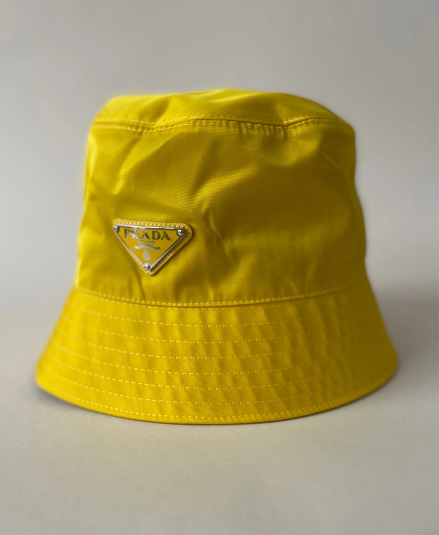 Prada Nylon Bucket Hat with triangle logo in Yellow — CONSUMED