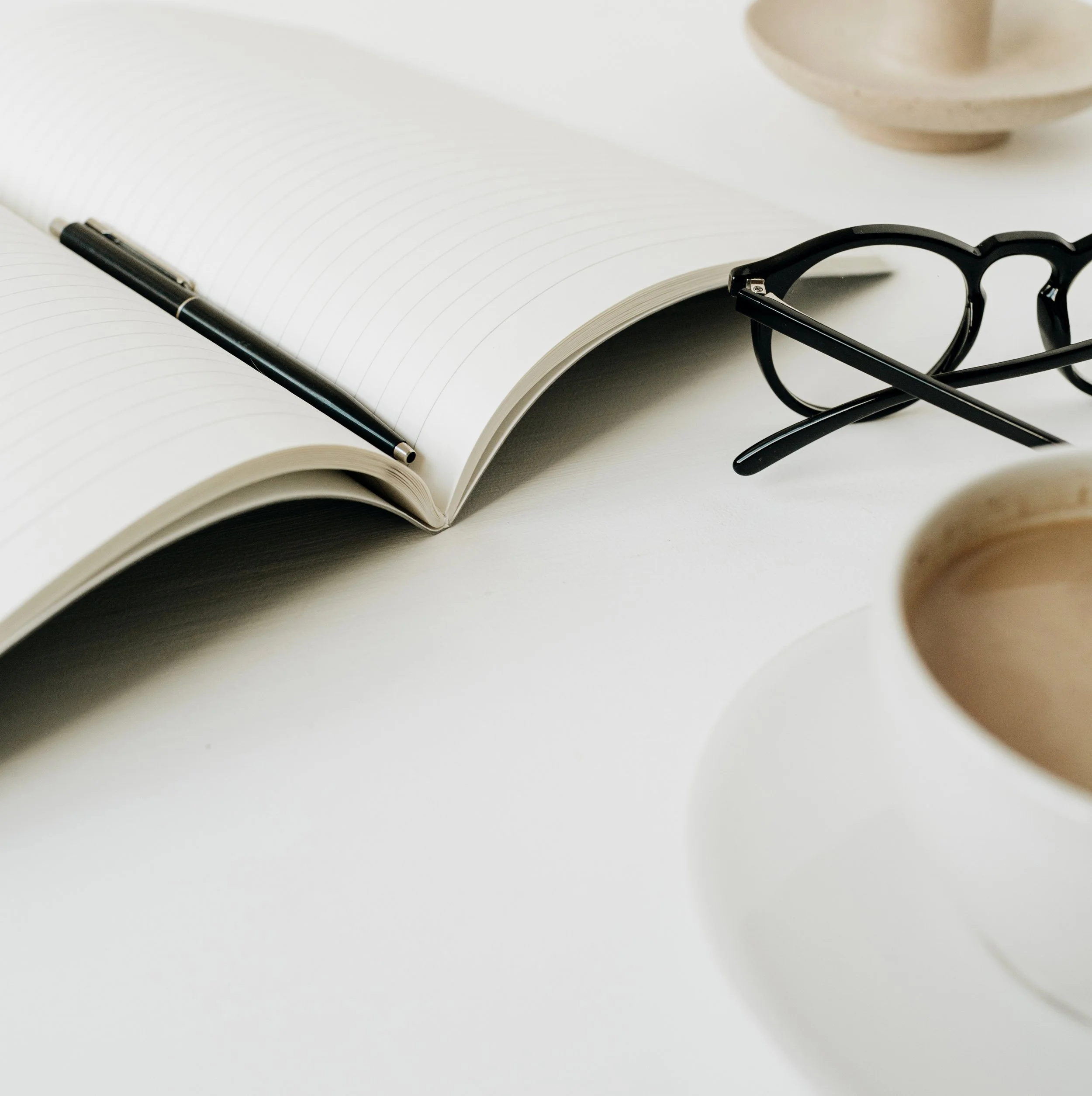 modern-home-office-desk-workspace-with-notebook-cup-coffee-glasses-white-background.jpg