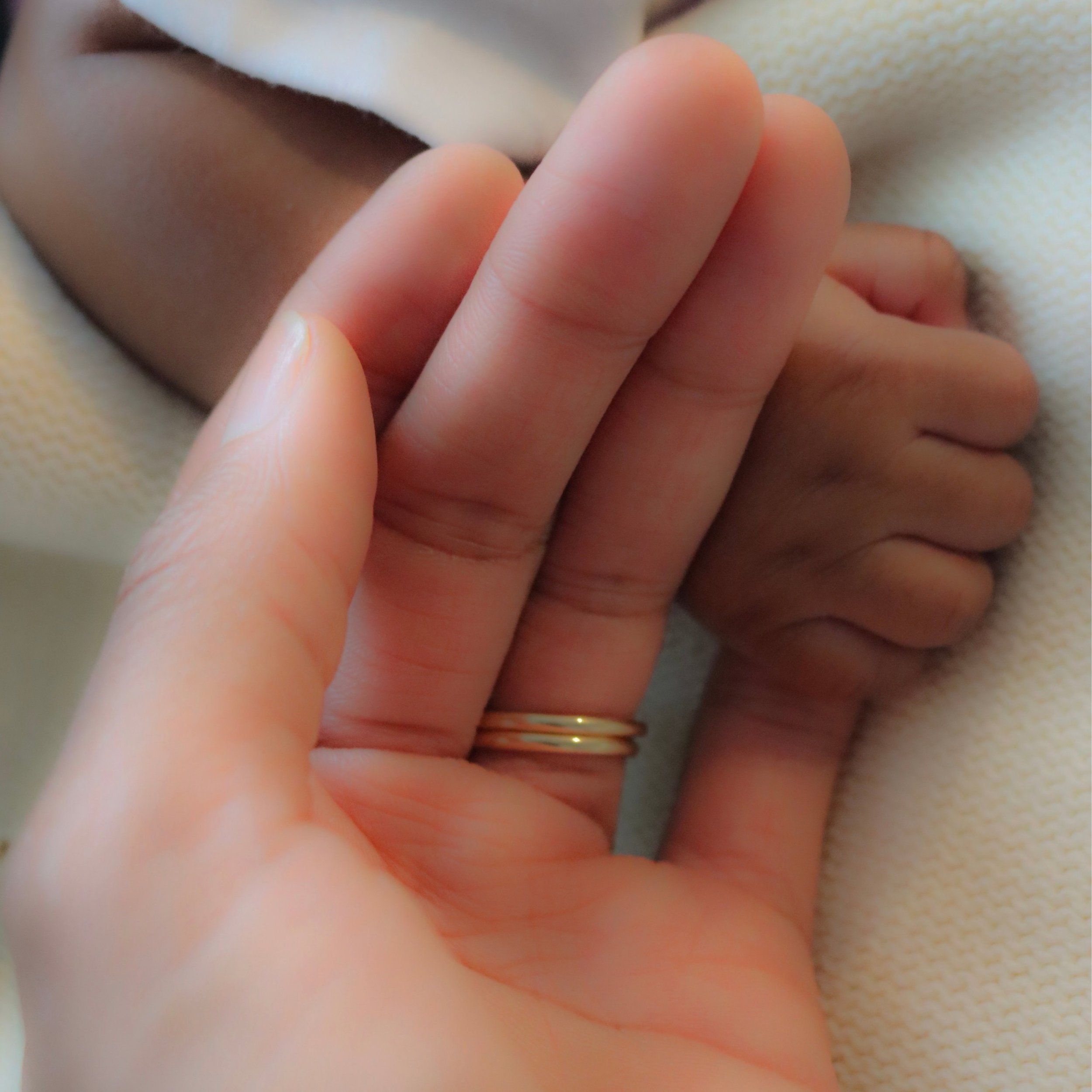 baby hand wrapped around finger