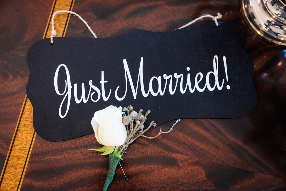 Inn on Montford Just Married sign with simple boutonniere