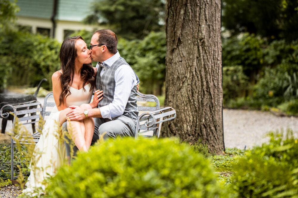 Couple kissing on a bench at their intimate wedding in Asheville, NC