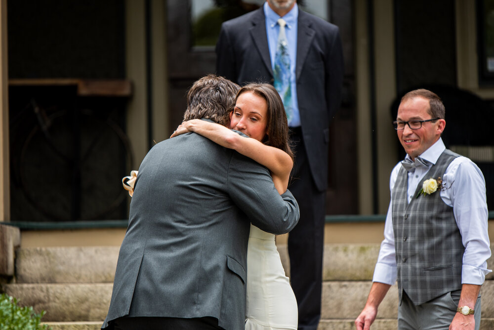 Bride hugs her father during her intimate wedding at the inn on montford