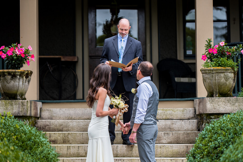 Bride and Groom looking at officiant during their intimate Asheville wedding