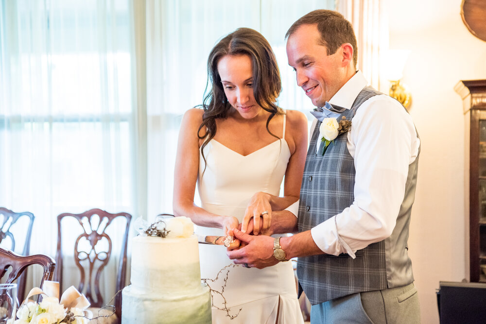 Bride and Groom cutting the cake at the inn on montford wedding venue asheville, nc