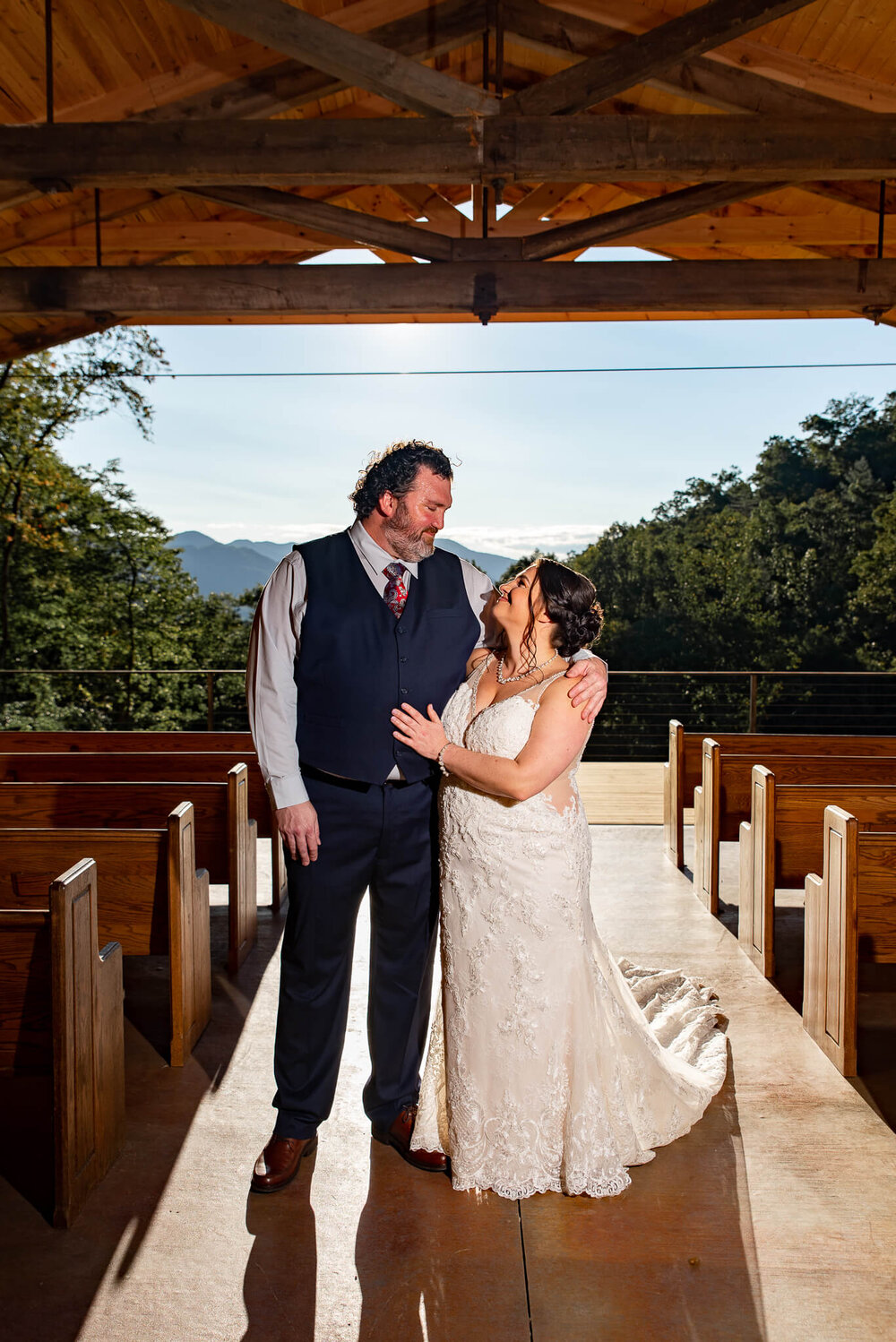 Bride and Groom looking at each other under wedding ceremony pavilion in the mountains at The Parker Mill