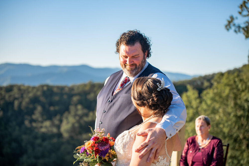 Groom looking at his bride during wedding ceremony in Whittier, NC captured by Nick Levine Photography