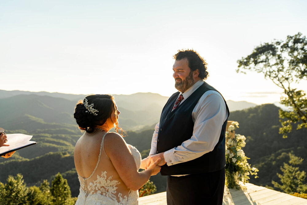 Bride and Groom holding hands during their elopement ceremony in the mountains of Whittier, NC