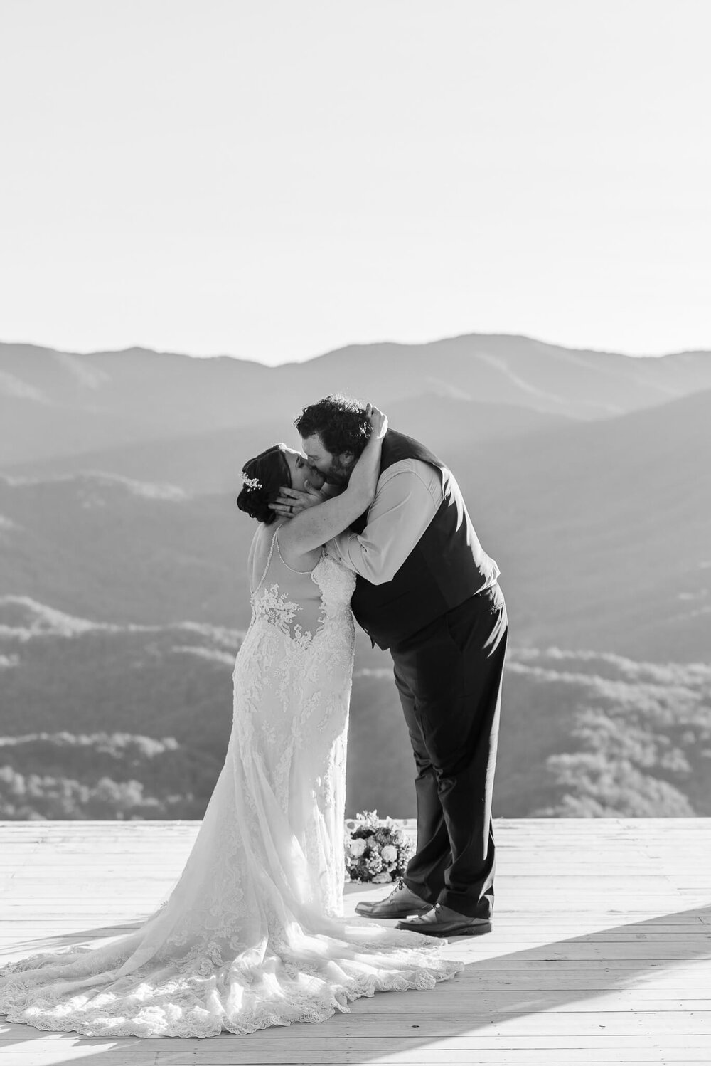 Bride and groom first kiss in black and white at The Parker Mill elopement venue