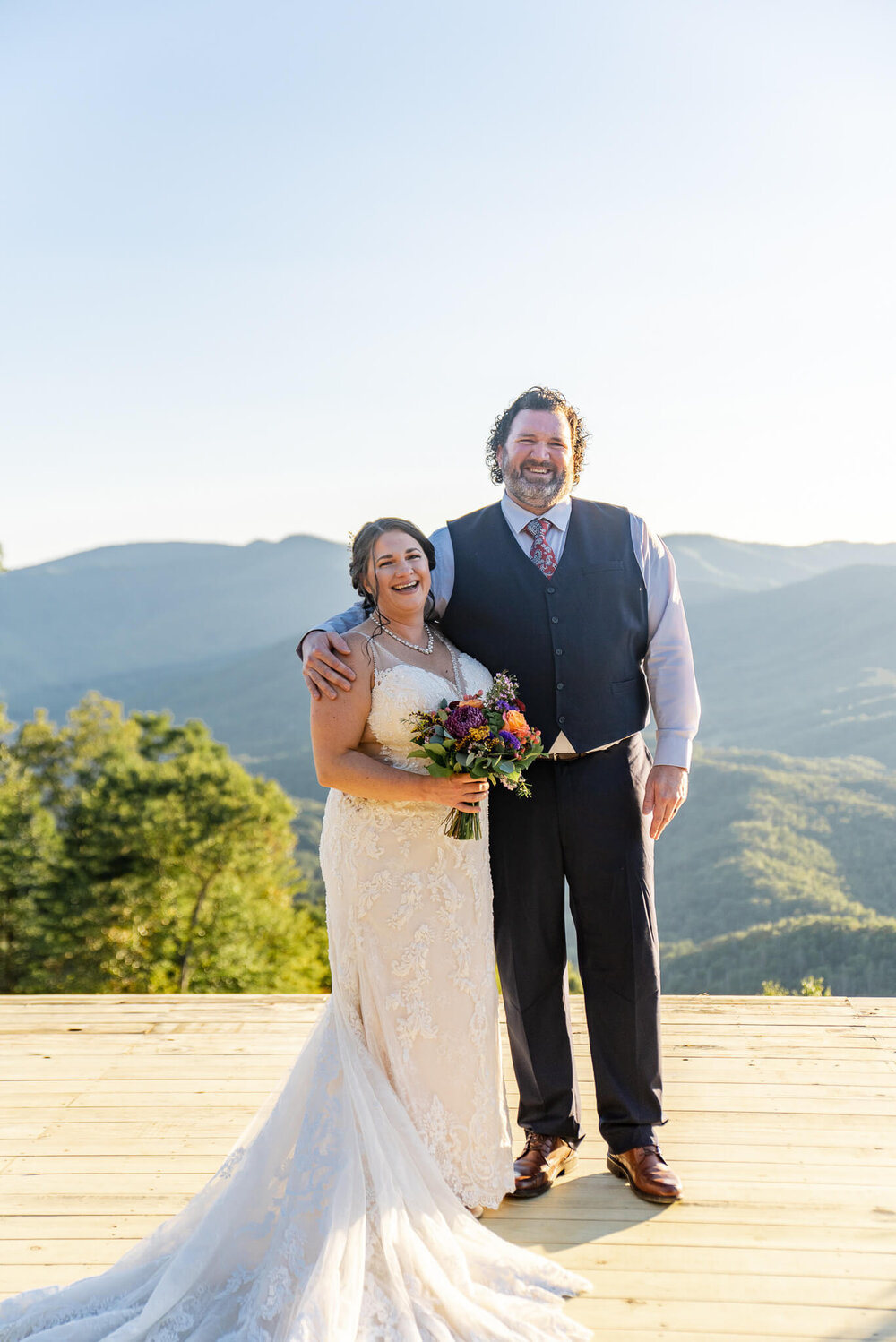 bride and groom laughing with joy after becoming a married couple photographed in Whittier, NC near Asheville