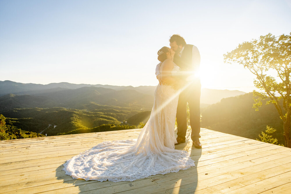 Bride and Groom kissing during golden hour after their mountaintop elopement ceremony at The Parker Mill