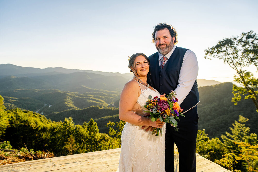 Bride and Groom posing surrounded by mountains and trees at The Parker Mill wedding venue