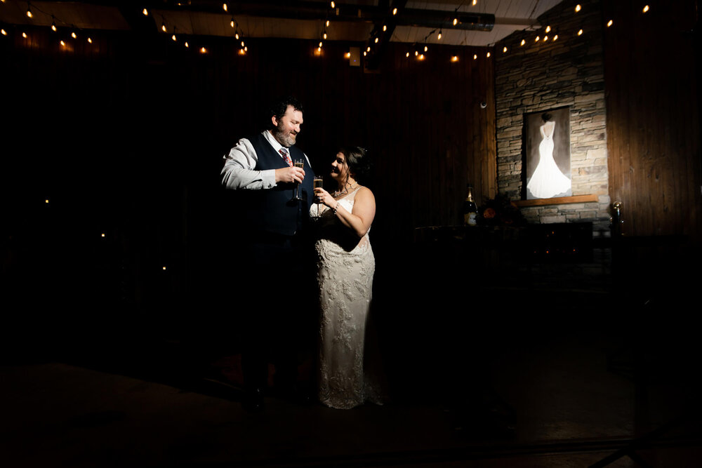 Creative wedding toast photo with bride and groom inside The Parker Mill wedding venue