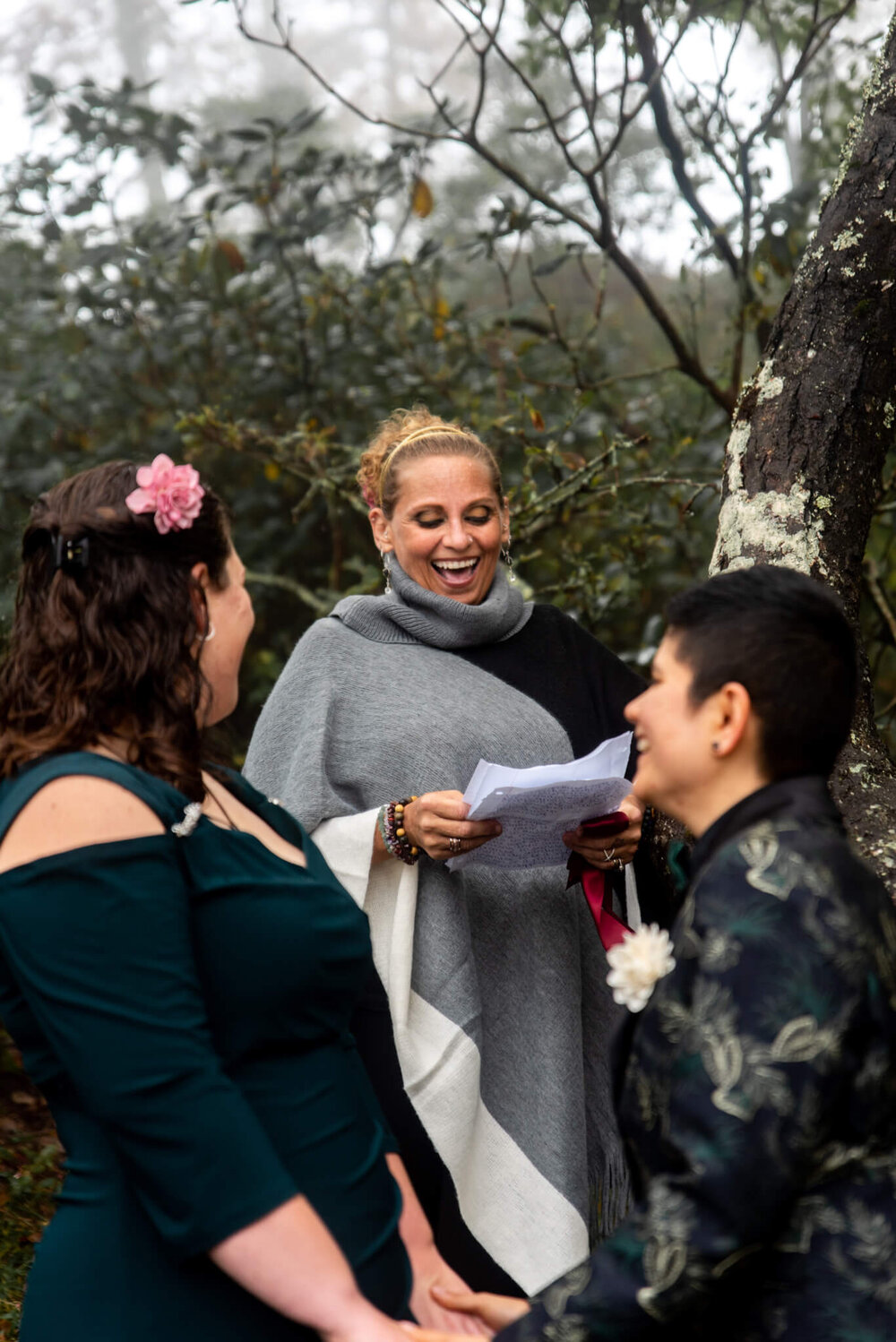 Wedding Officiant laughing and smiling during the wedding ceremony in the foggy woods of Bearwallow Mountain