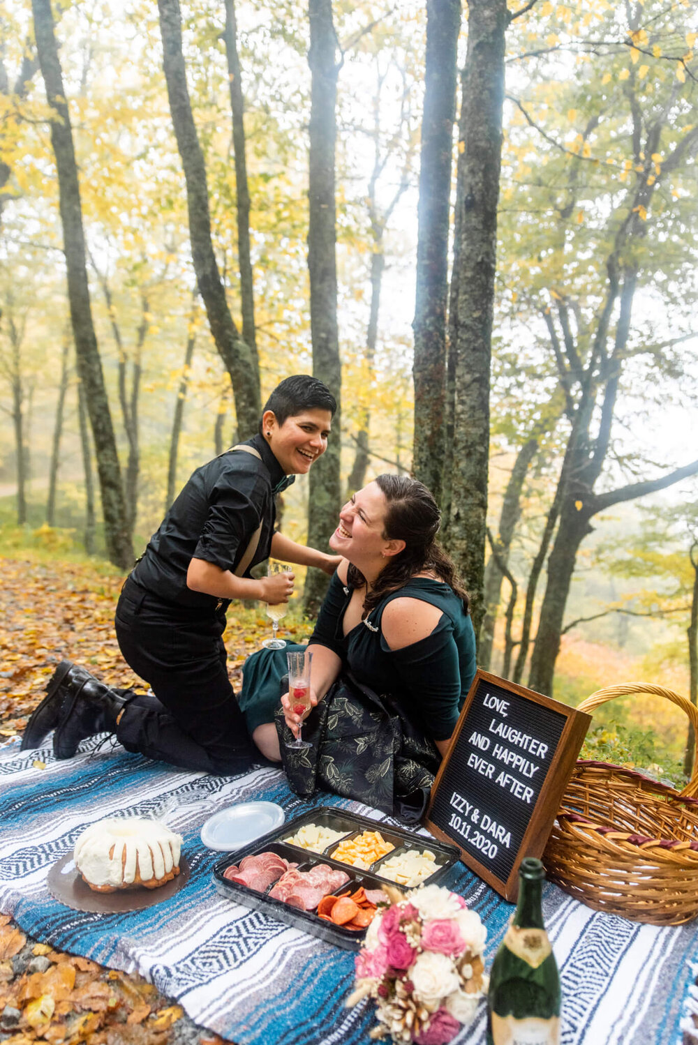 Wedding couple laughing during their elopement picnic in the forests of asheville, nc