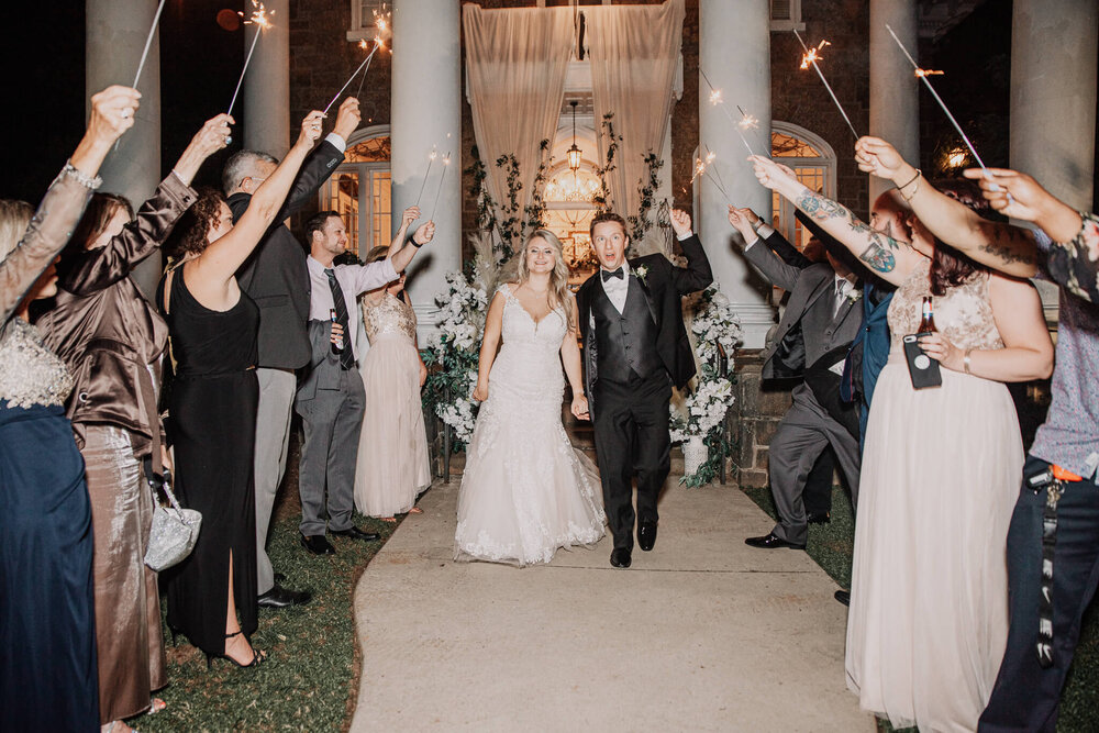 bride and groom sparkler exit outside the gassaway mansion wedding venue in greenville sc