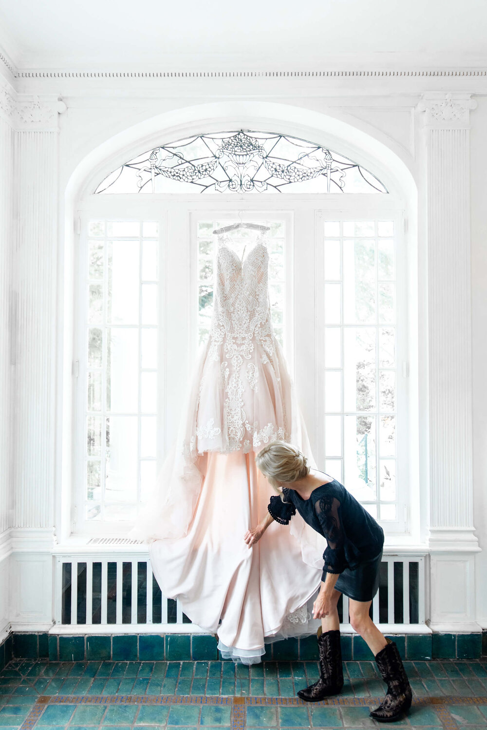 wedding dress on a hanger at the gassaway mansion by nick levine photography