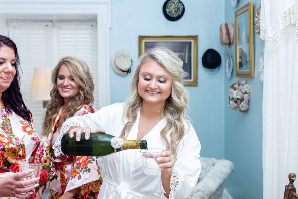 bridal party and with bride in robes in the gassaway mansion wedding venue bridal suite