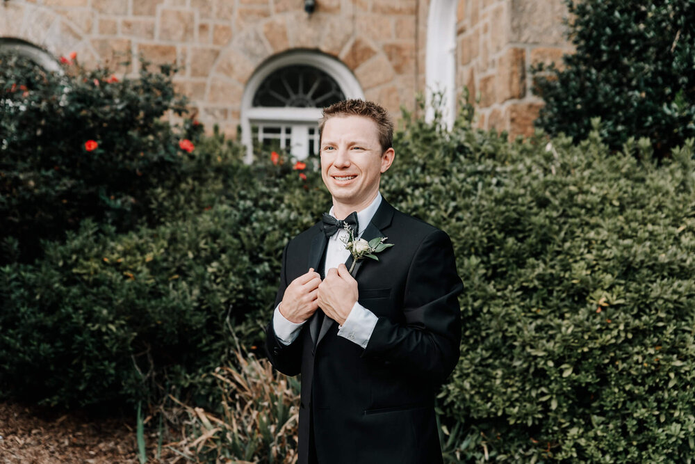 photograph by nick levine photography of the groom outside of the gassaway mansion wedding venue in greenville sc