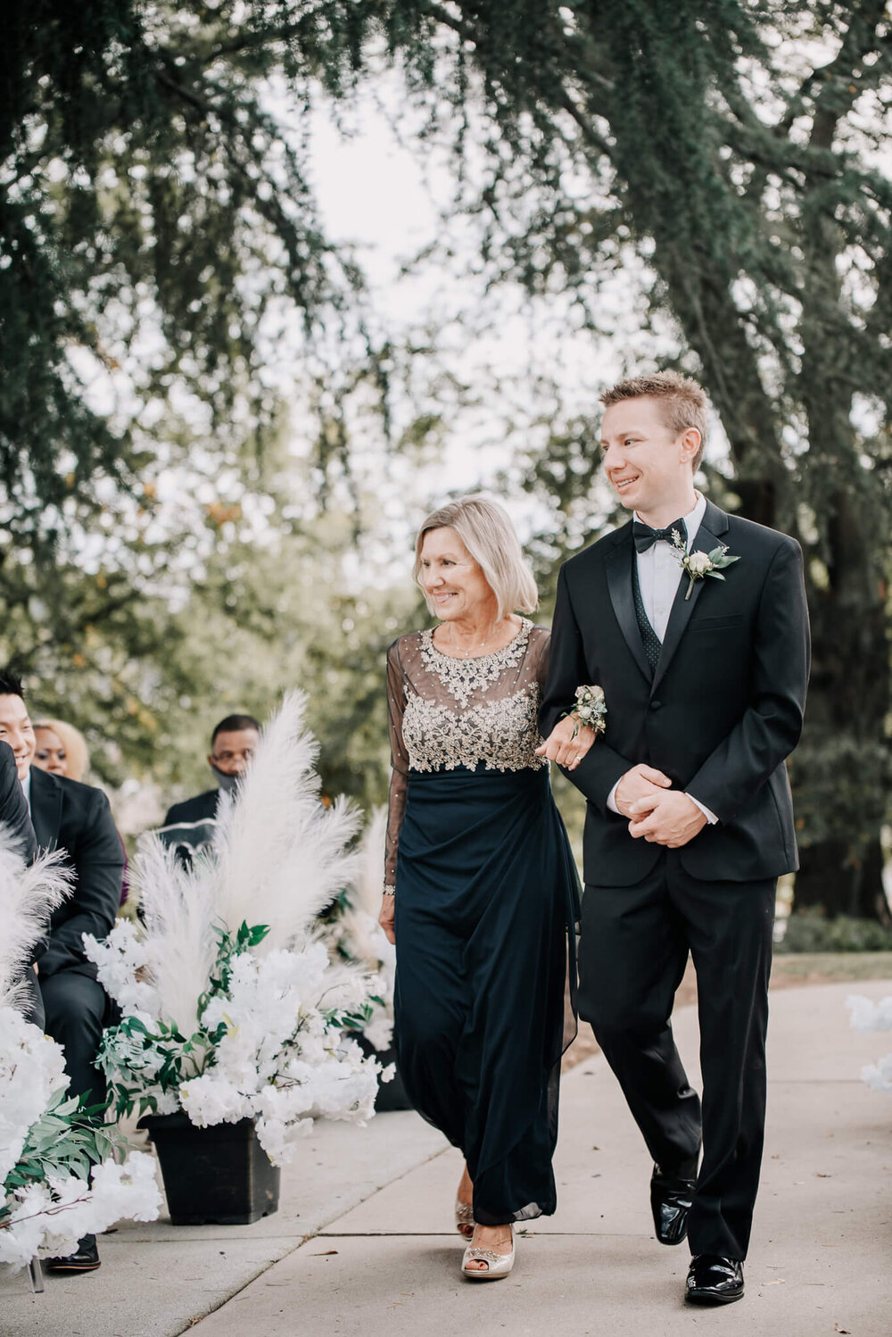 groom and his mother walking down the aisle at his wedding photographed by nick levine photography
