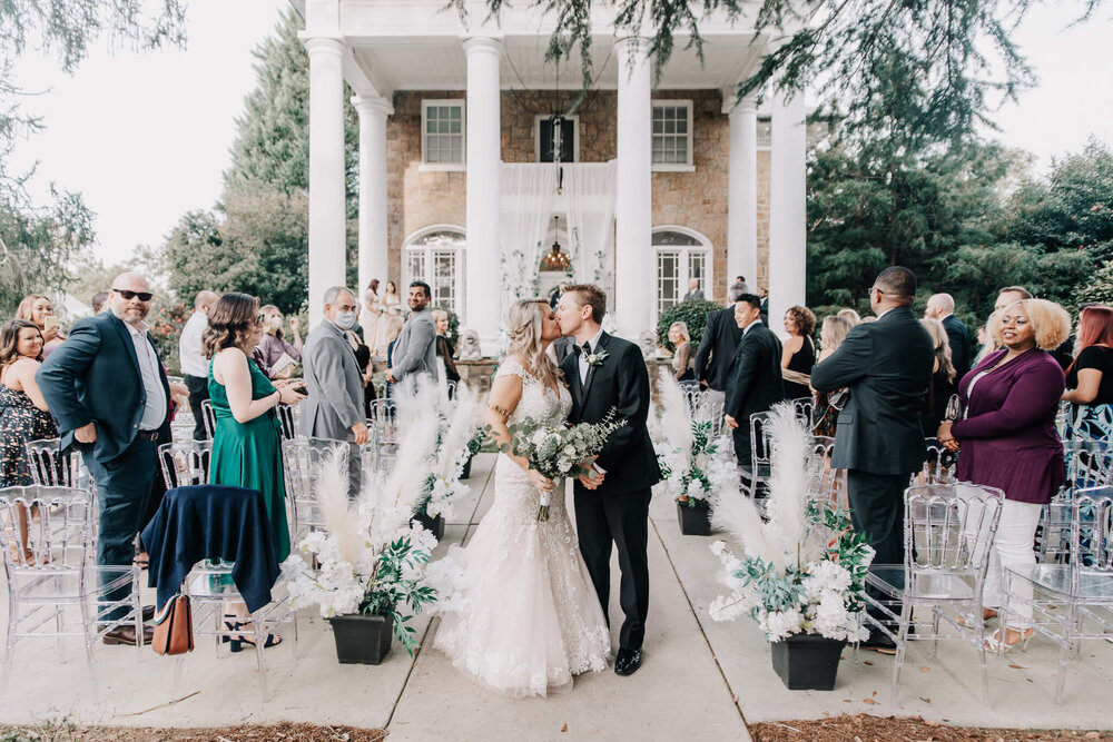 bride and groom at their wedding ceremony at the gassaway mansion in greenville sc