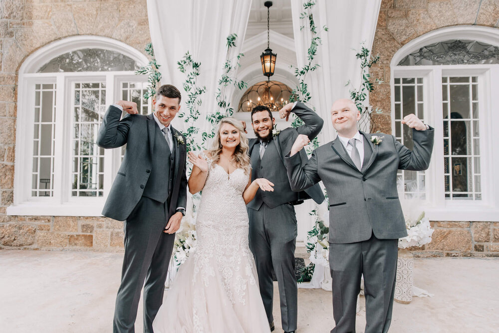 bride and groomsmen posing in front of the gassaway mansion front steps by nick levine photography