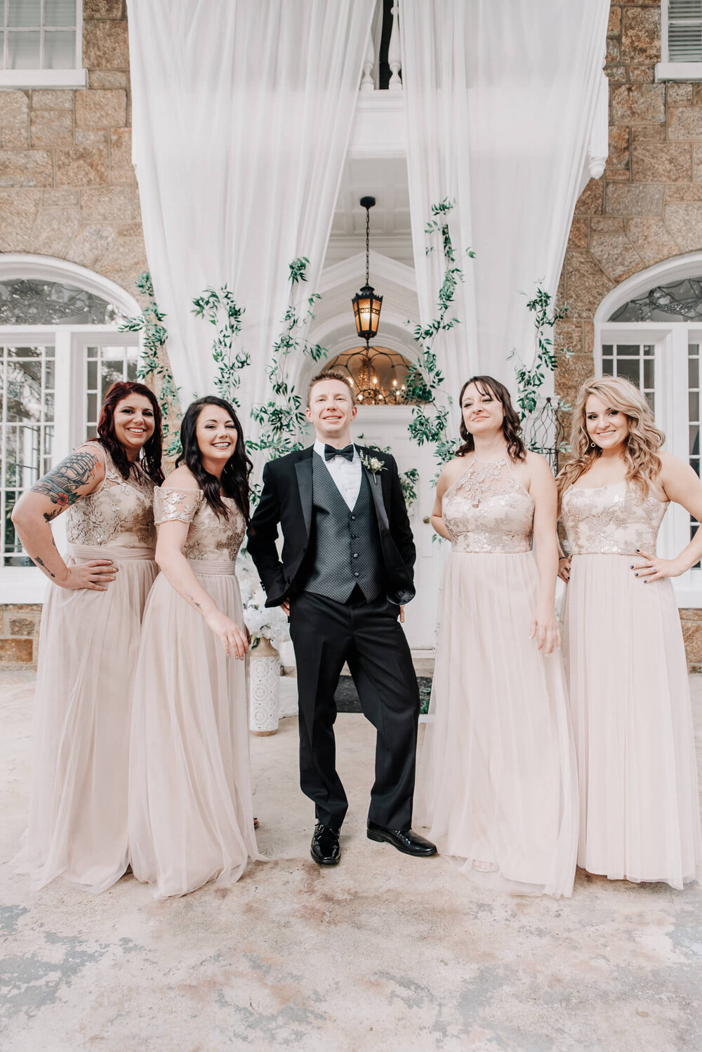 groom and bridesmaids posing together at the gassaway mansion by nick levine photography