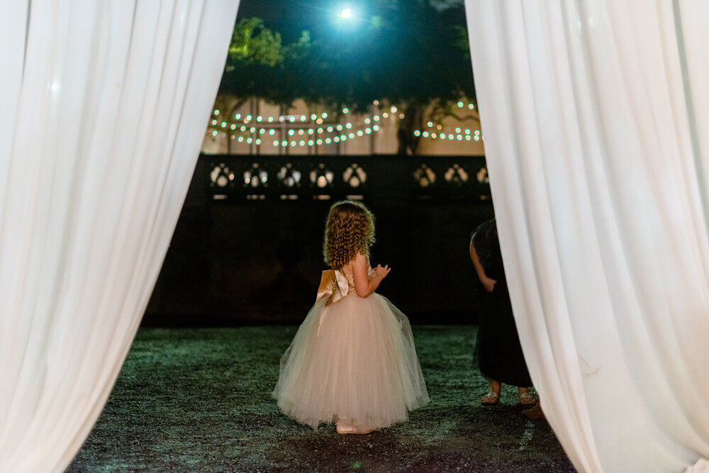 flower girl standing outside the wedding tent at biltmore estate wedding