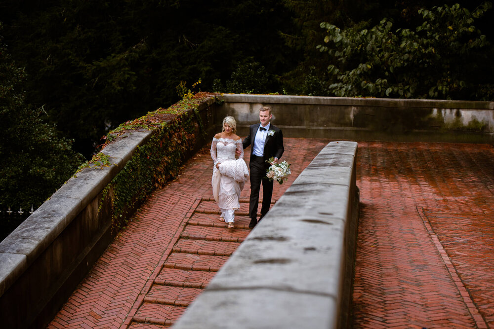 Groom and his bride walking together before their wedding ceremony at the biltmore estate in asheville nc