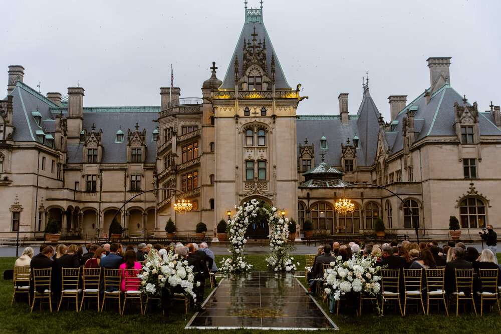 wedding ceremony in front of the biltmore estate house in asheville, nc by asheville wedding photographer