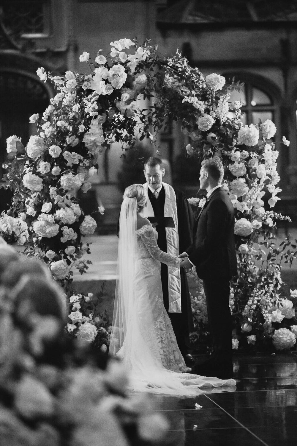 bride and groom at the wedding alter in front of the biltmore estate house