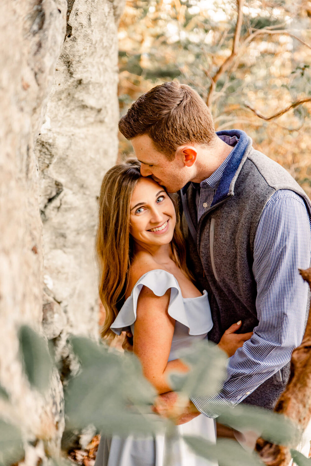 engaged couple walking through the forest during their fall engagement session with nick levine photography