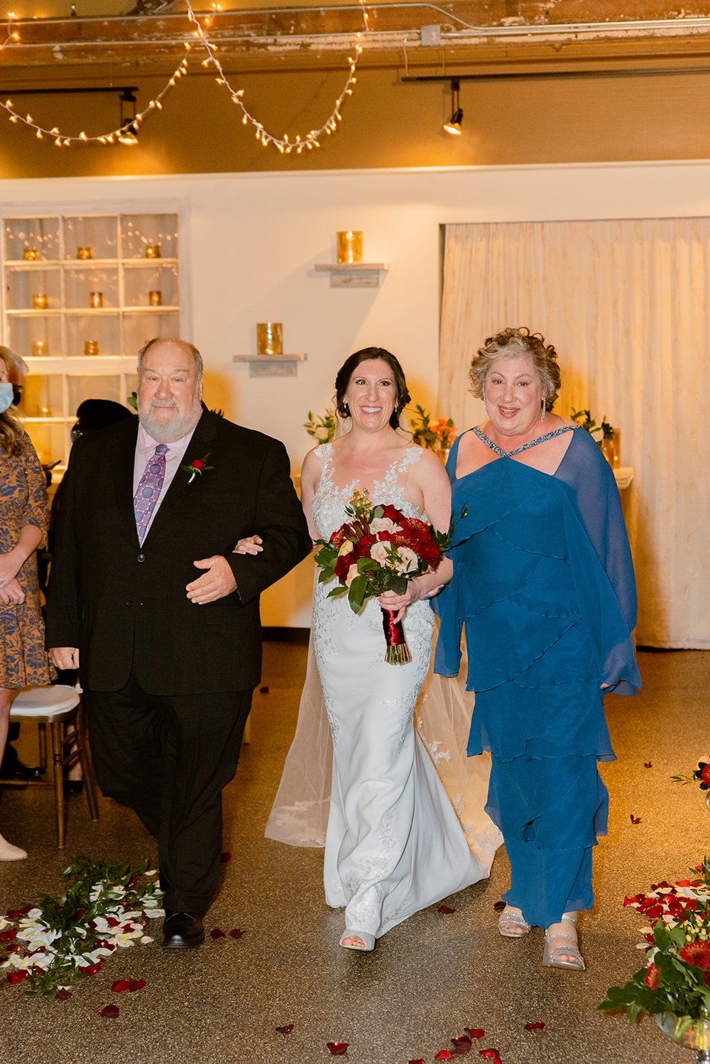 bride and her parents walking down the aisle at the venue asheville