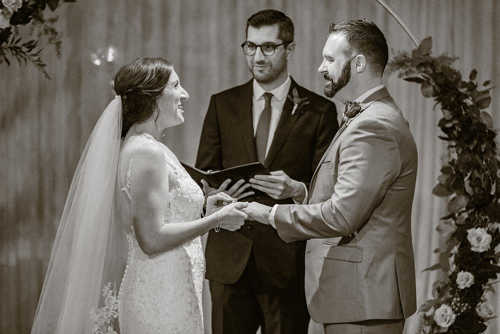 bride and groom exchanging rings during their asheville wedding at the venue in downtown