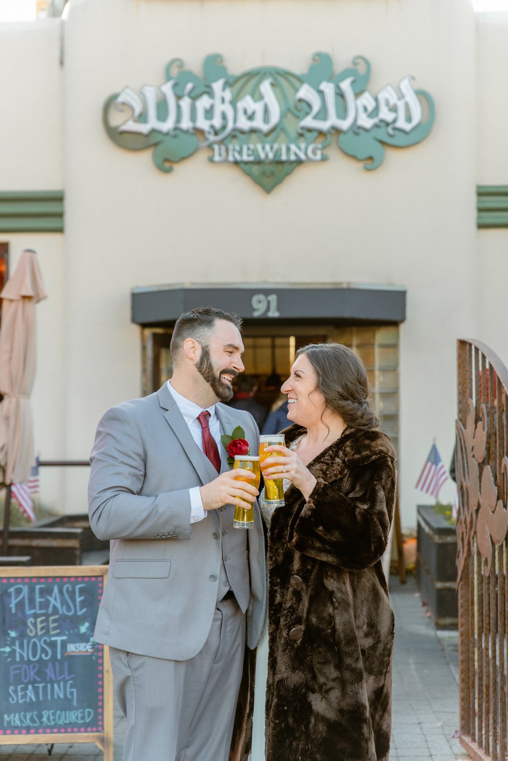 bride and groom at wicked weed brewing in asheville drinking beer