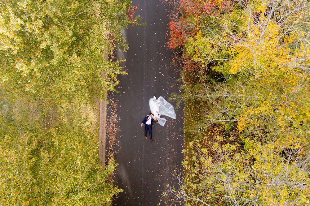 Unique drone photo of wedding couple in the fall foliage by nick levine photography
