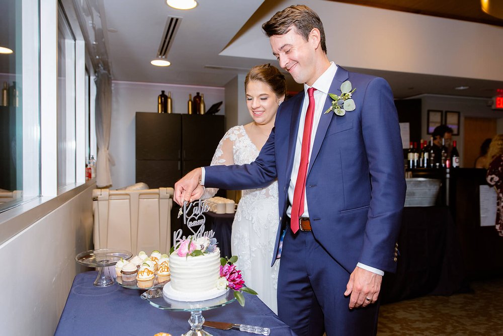 bride and groom cutting cake during their wedding reception photographed by asheville wedding photographer nick levine photography
