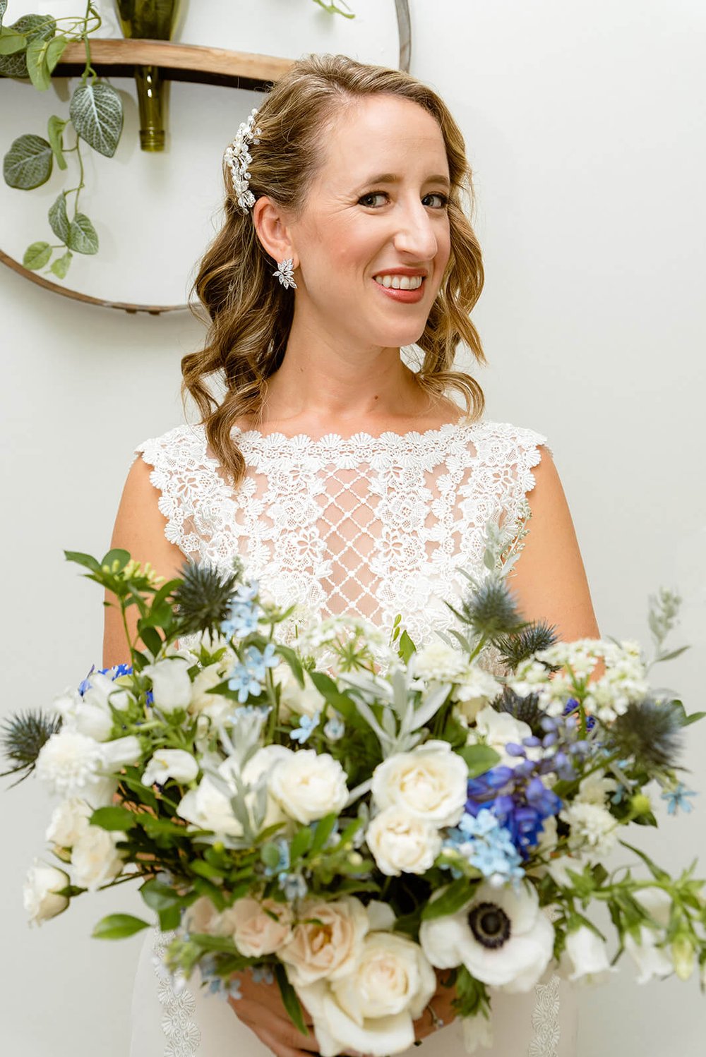 bride posing with her floral bouquet before her wedding at Highland Brewery in Asheville, NC