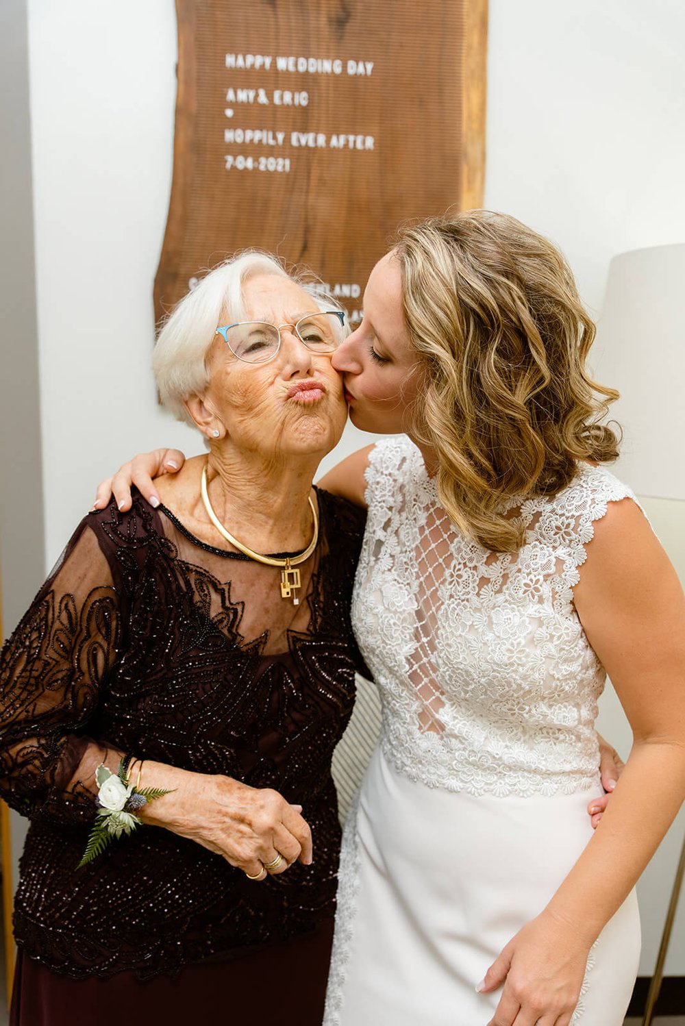 bride and grandma kissing during wedding at asheville wedding venue highland brewery