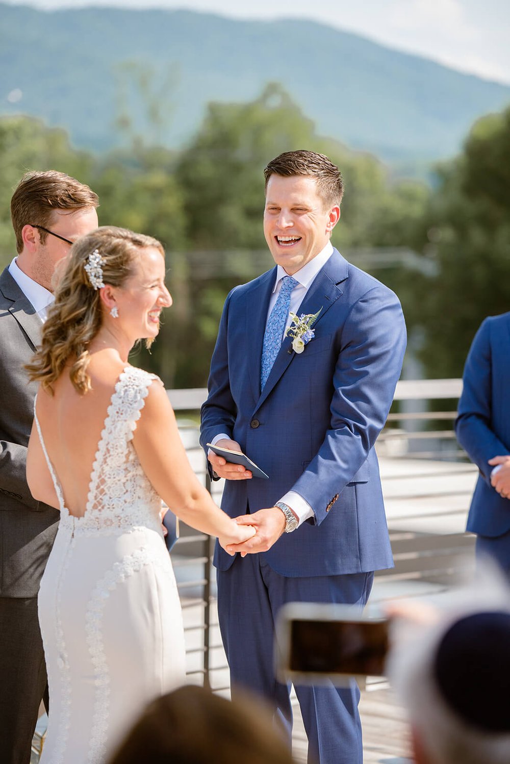 groom laughing during his wedding vows photographed by asheville wedding photographer nick levine photography