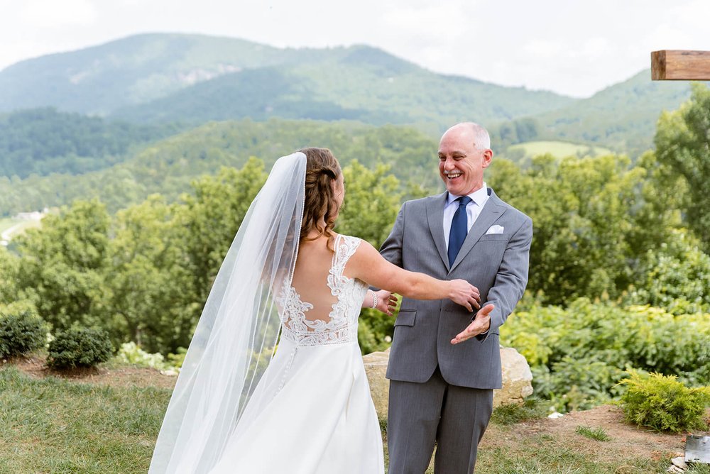 father and daughter first look at point lookout vineyards asheville wedding venue