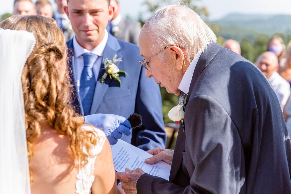 grandpa at wedding reading a bible passage photo