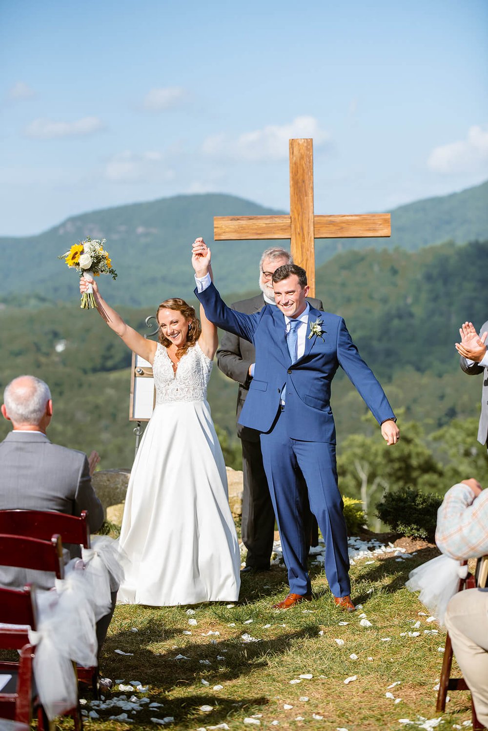 bride and groom cheering after first kiss
