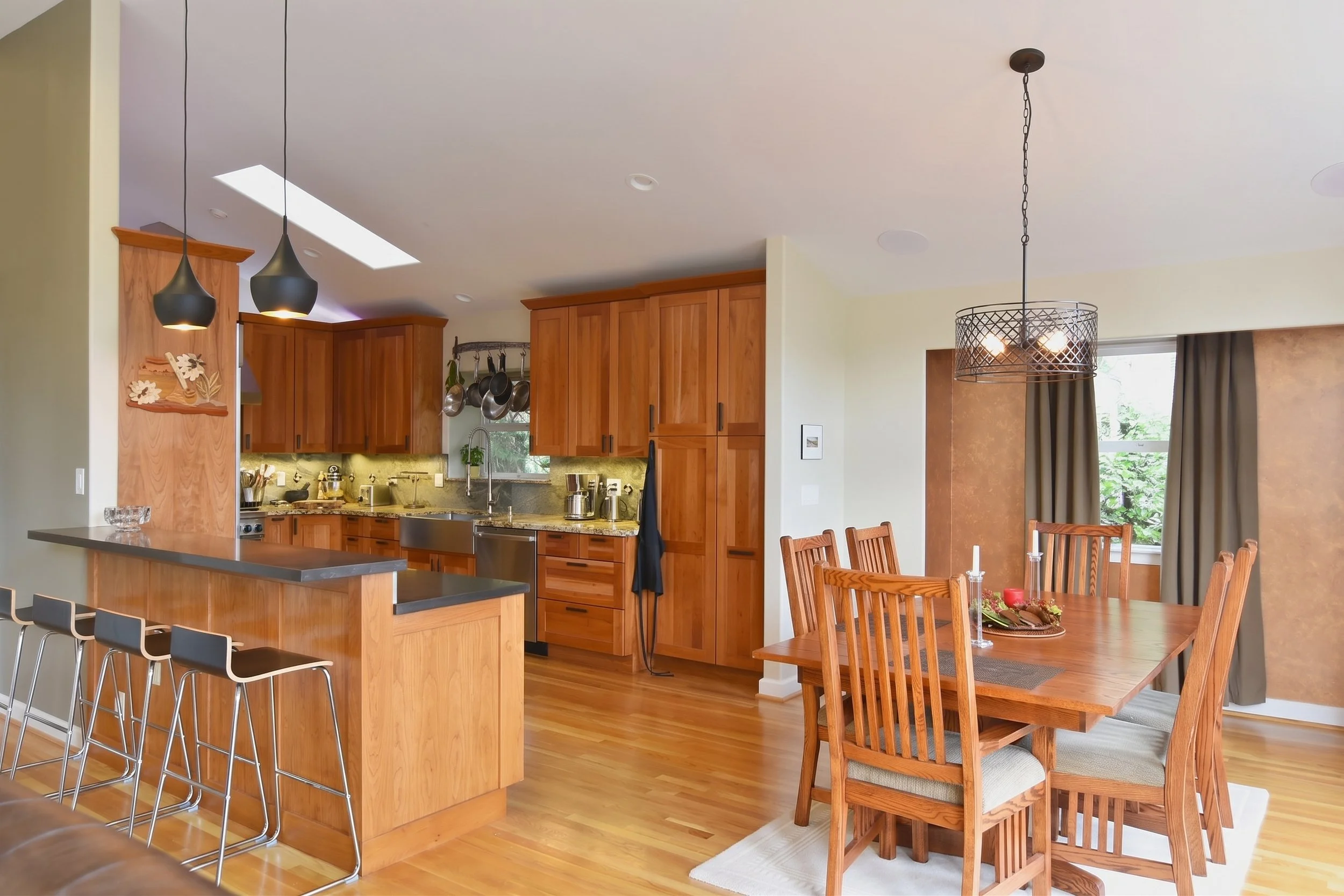 Kitchen open to the dining area, with bar stools at the raised counter.