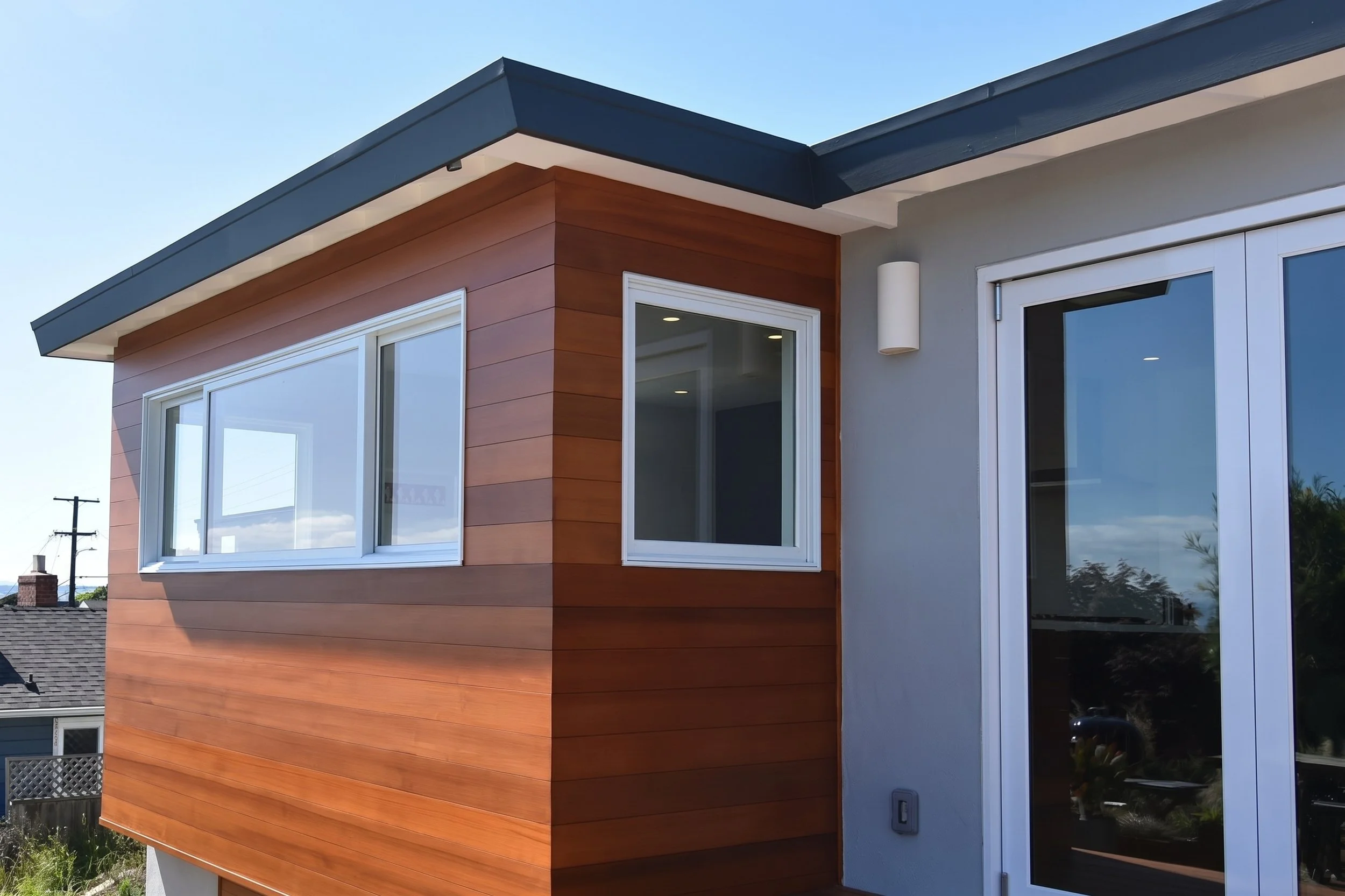 Exterior of the kitchen addition with wood siding.