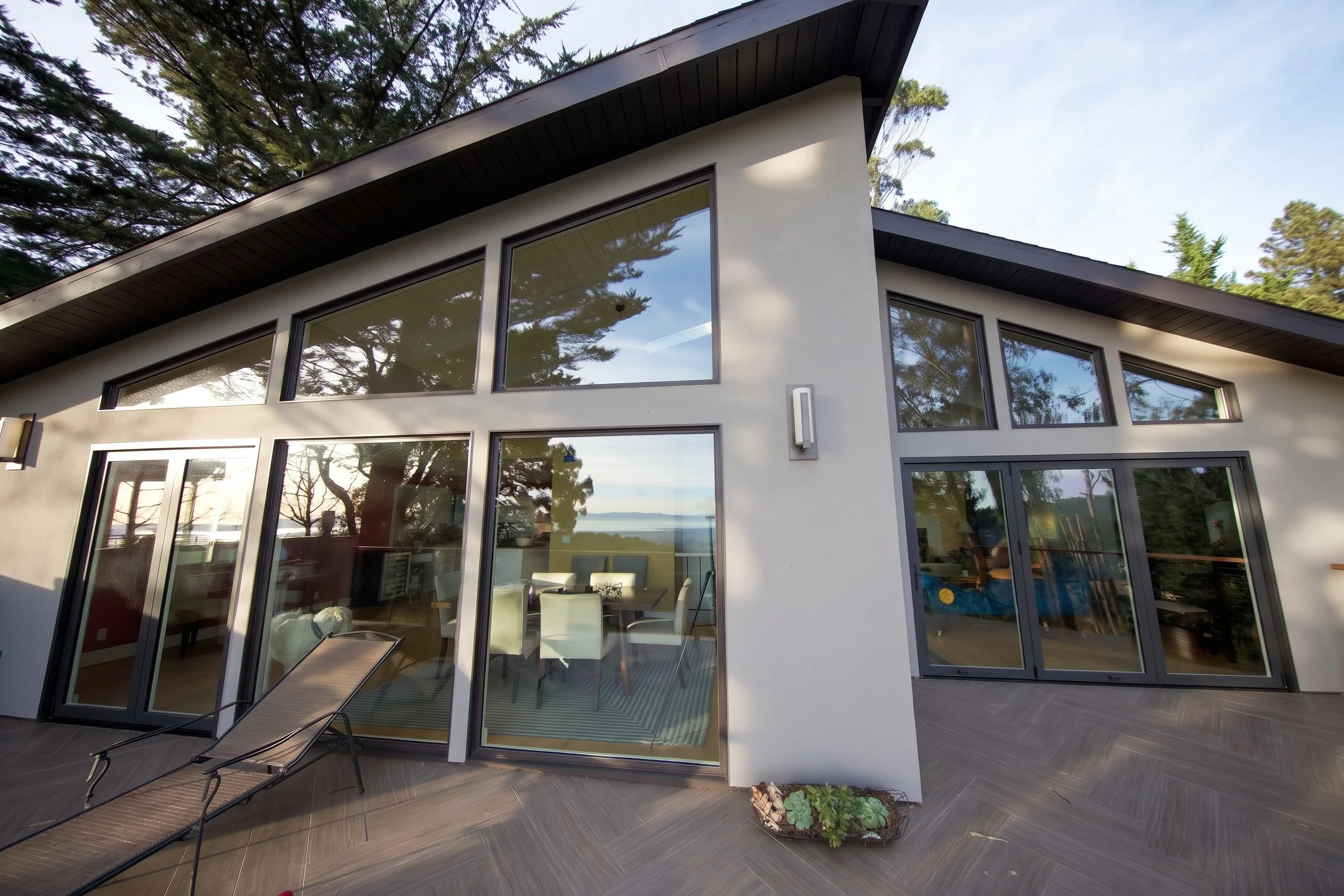 Glass wall addition opening onto the upper deck.