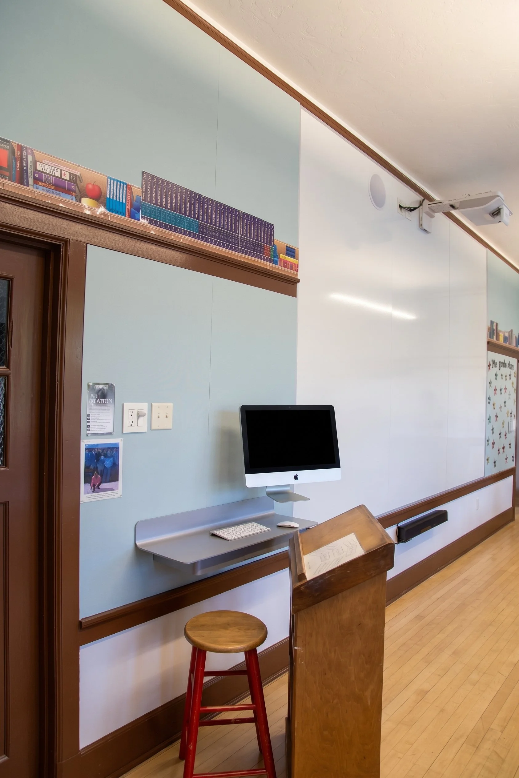 Computer station at the end of the whiteboard wall.