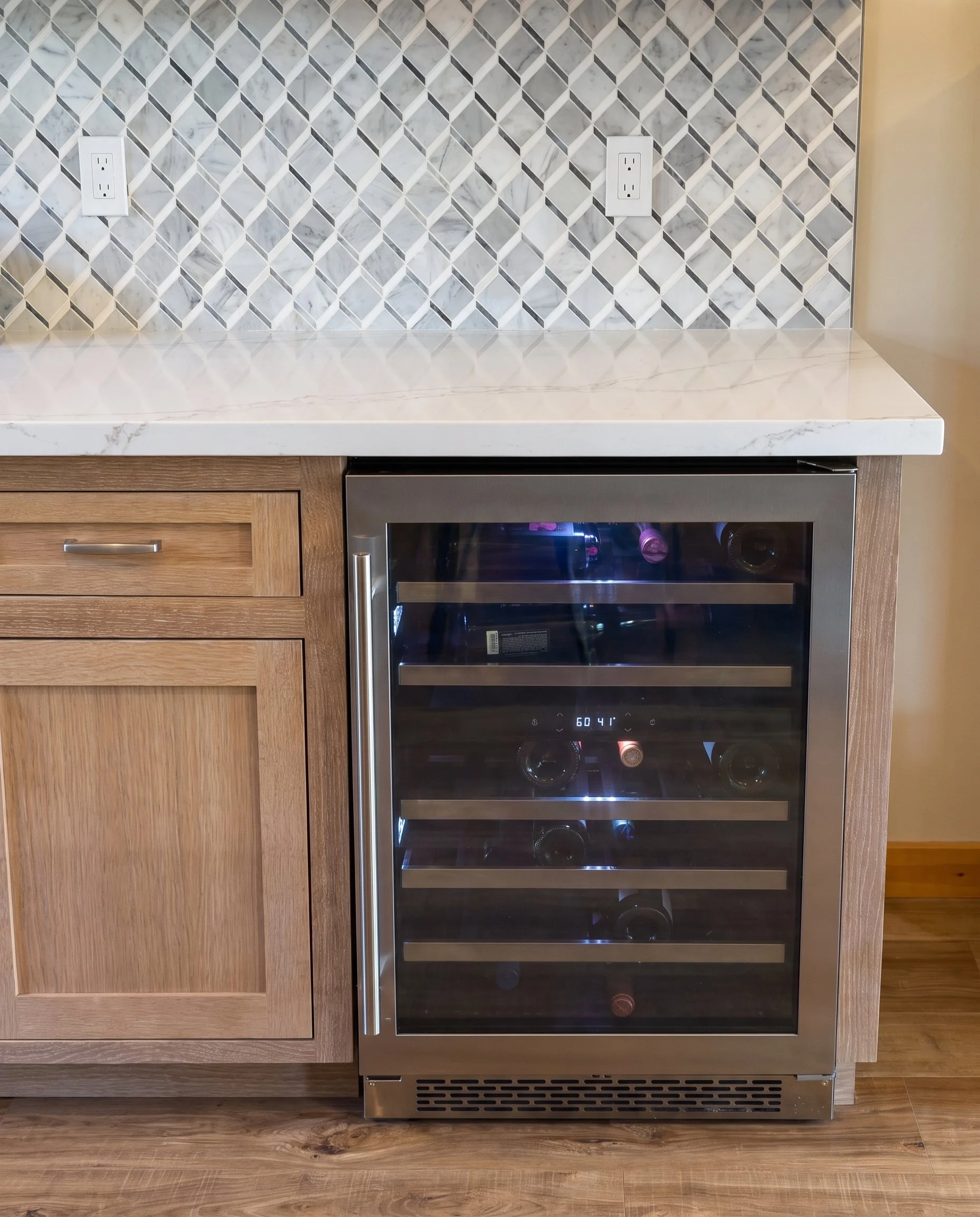 Built-in beverage refrigerator at the end of the cabinet run.
