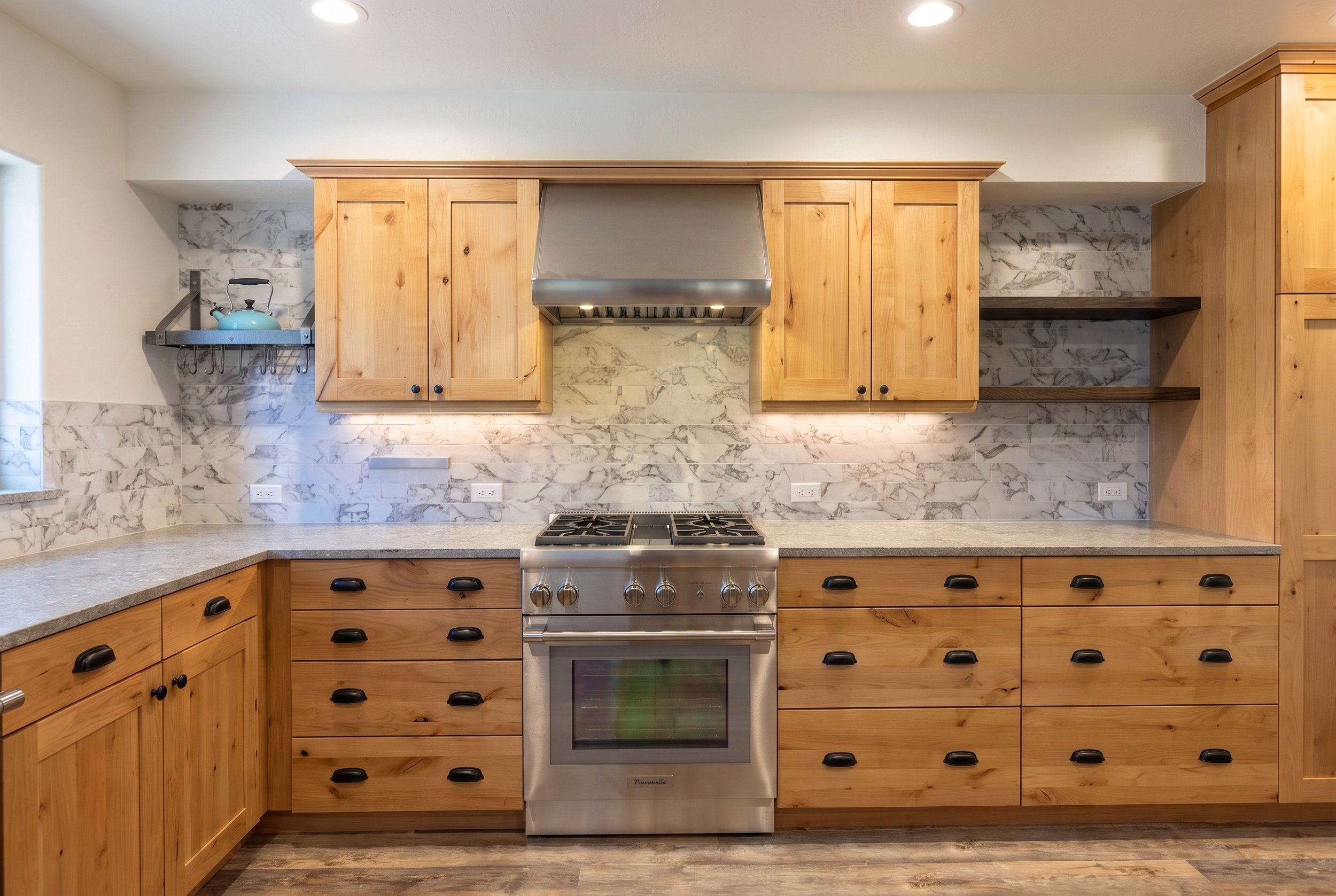 Range wall with knotty alder cabinets, a stone backsplash to the ceiling and floating shelves.