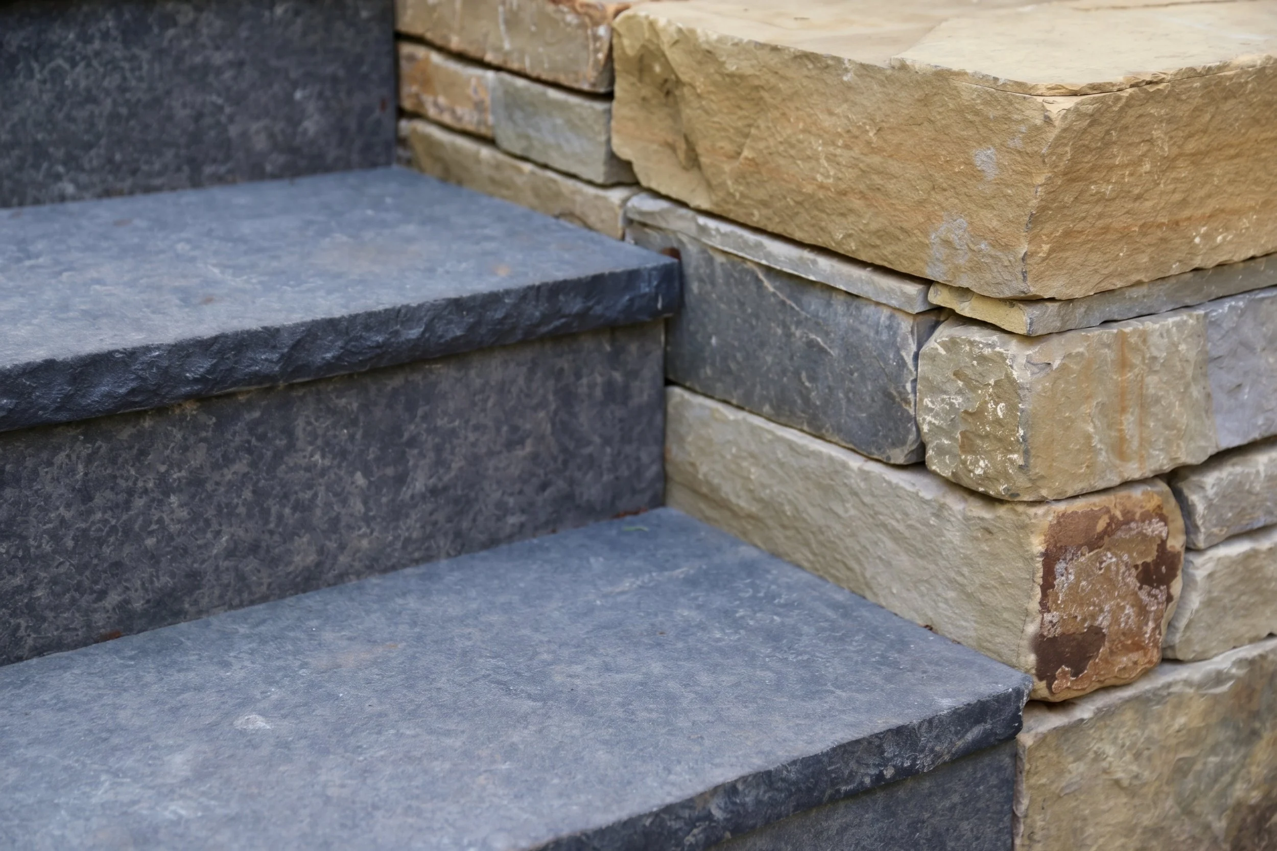Bluestone steps against a stone wall.